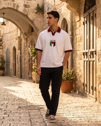 Palestine Polo Shirt worn by a model in an old stone alley